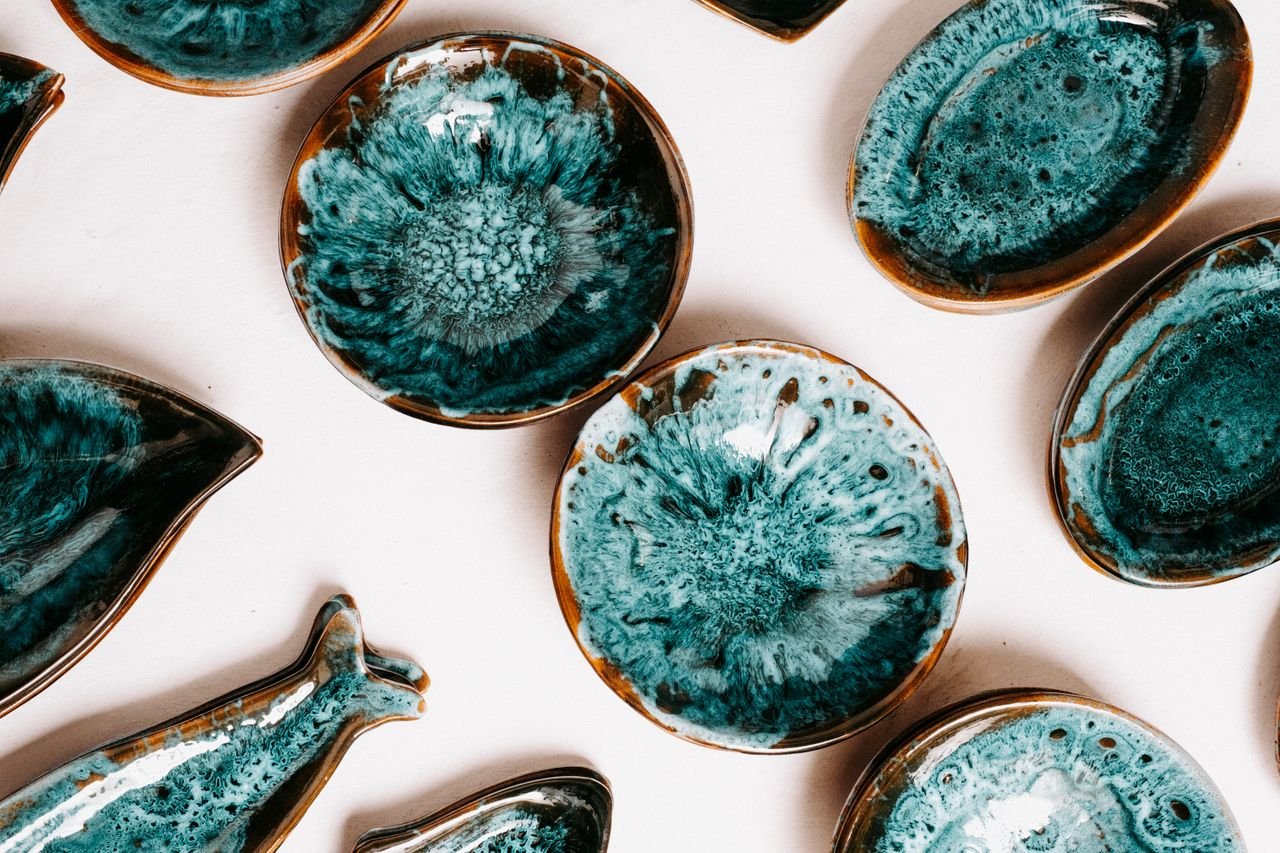 Home An artistic collection of handcrafted turquoise pottery bowls and plates.