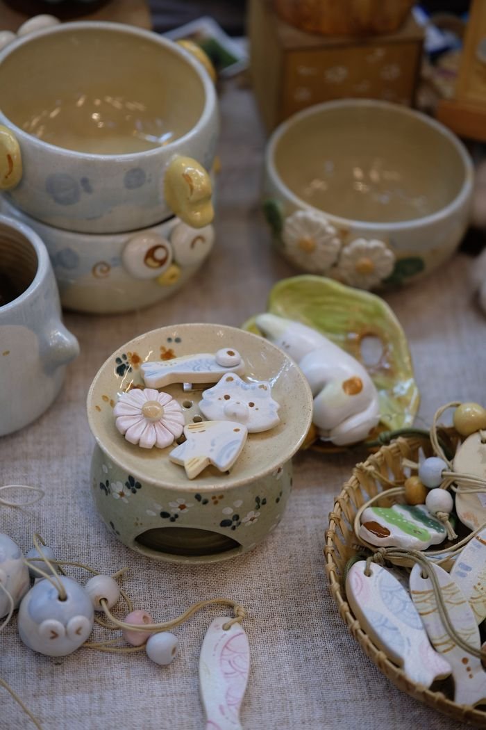 Home A collection of artfully crafted ceramic decor with whimsical designs and pastel hues.